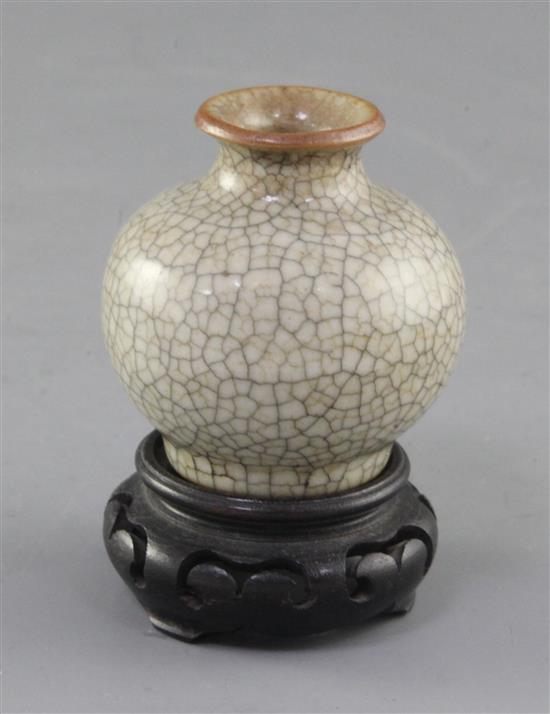 A small Chinese crackle-glaze globular vase, 18th/19th century, height 5.8cm, wood stand
